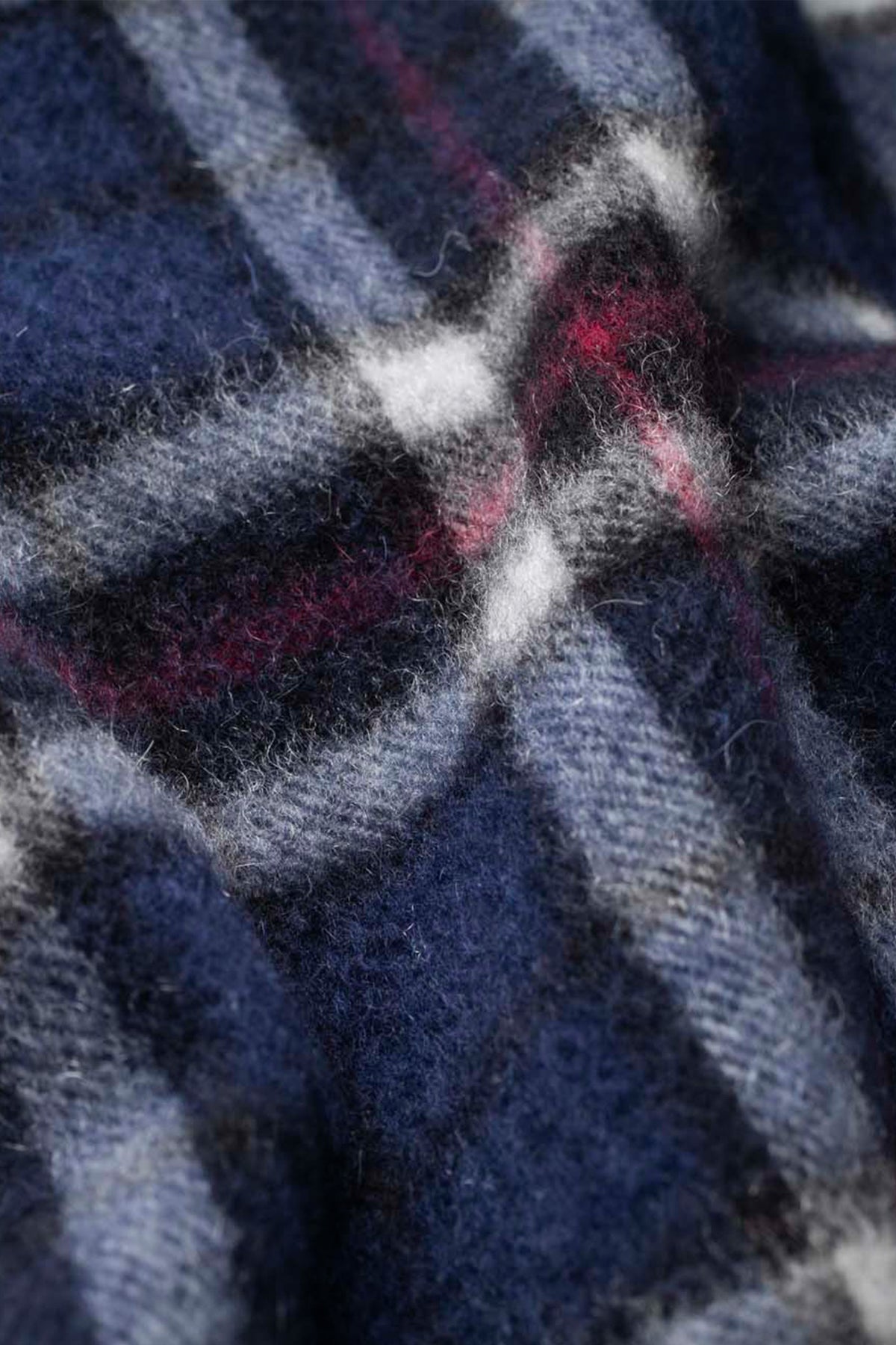 Close-up of the Scotty Thompson Cashmere Scarf in Navy showing soft brushed texture with red and white plaid detail