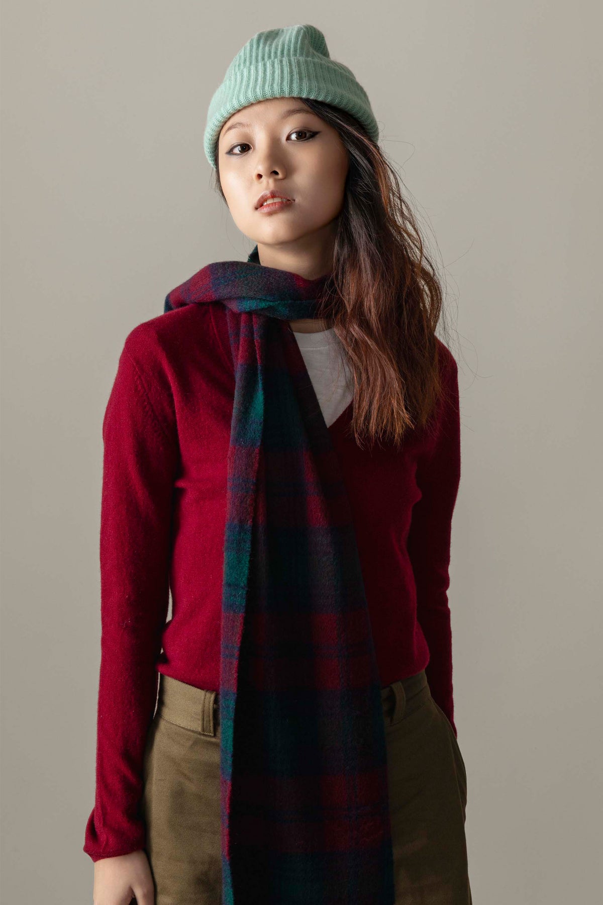 Made in Scotland Heritage Cashmere Scarf in Lindsay tartan with deep red, navy, and teal plaid, worn loosely knotted over a burgundy sweater