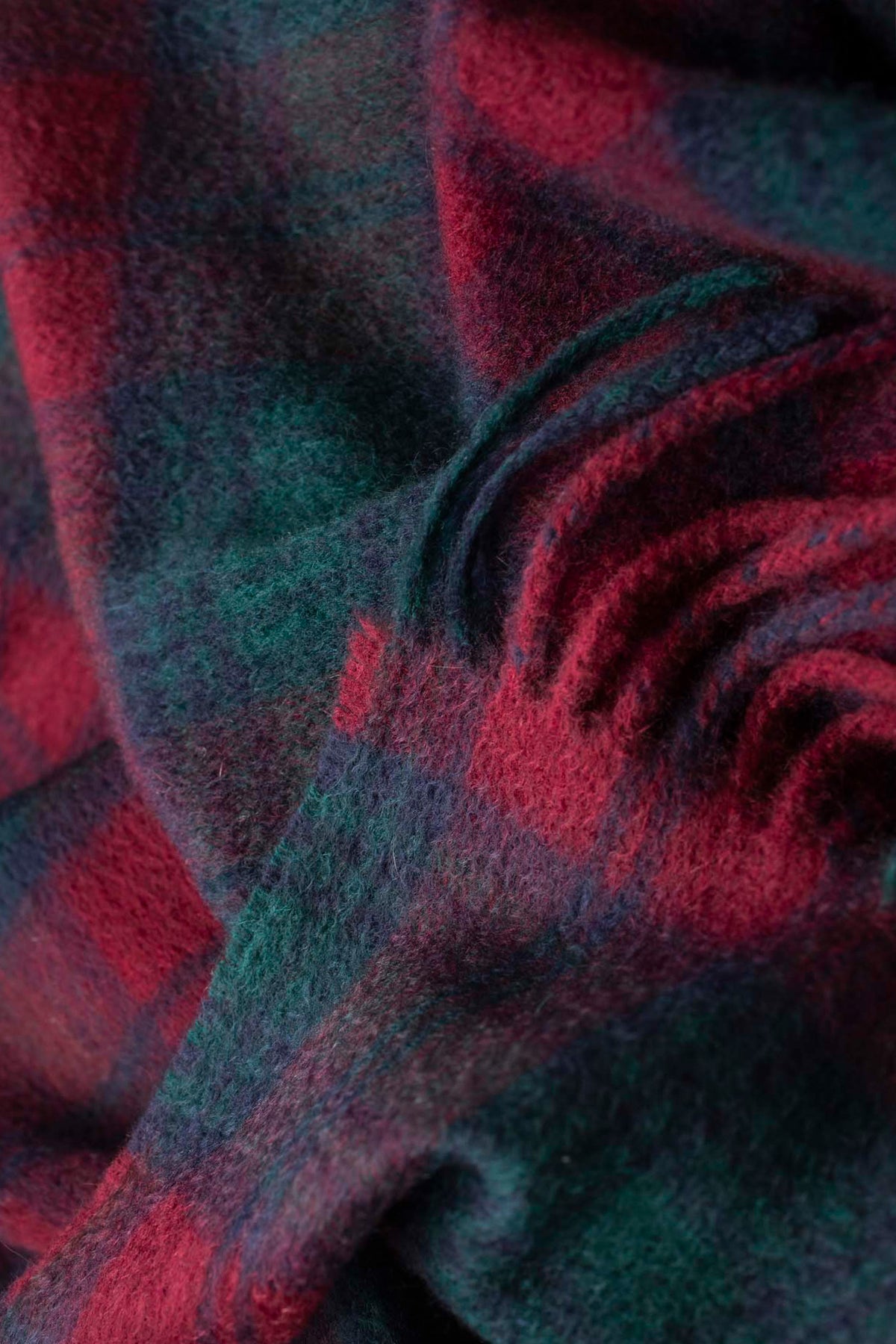 Close-up of the soft brushed cashmere texture on the Heritage Cashmere Scarf - Lindsay in red and green tartan plaid