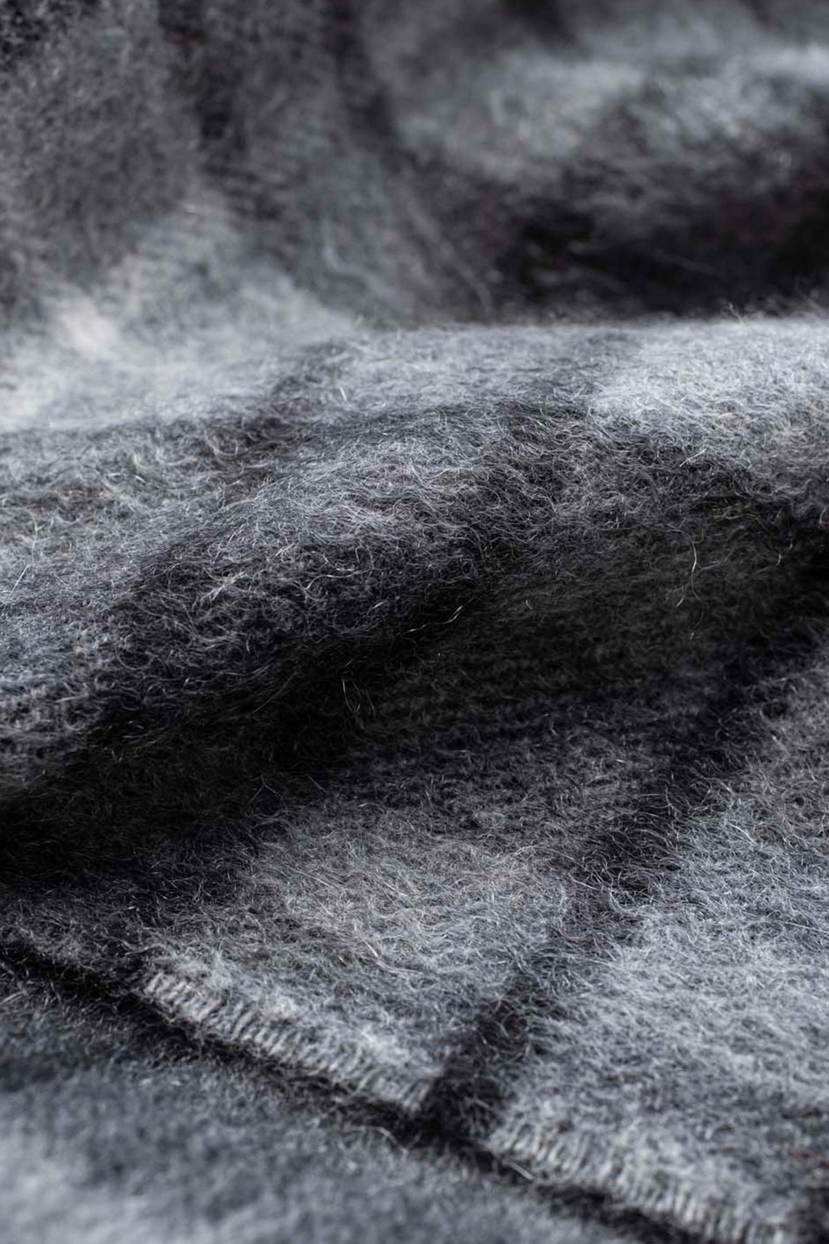 Close-up of the soft brushed cashmere texture on the Made In Scotland Heritage Cashmere Scarf in Buchanan Grey plaid