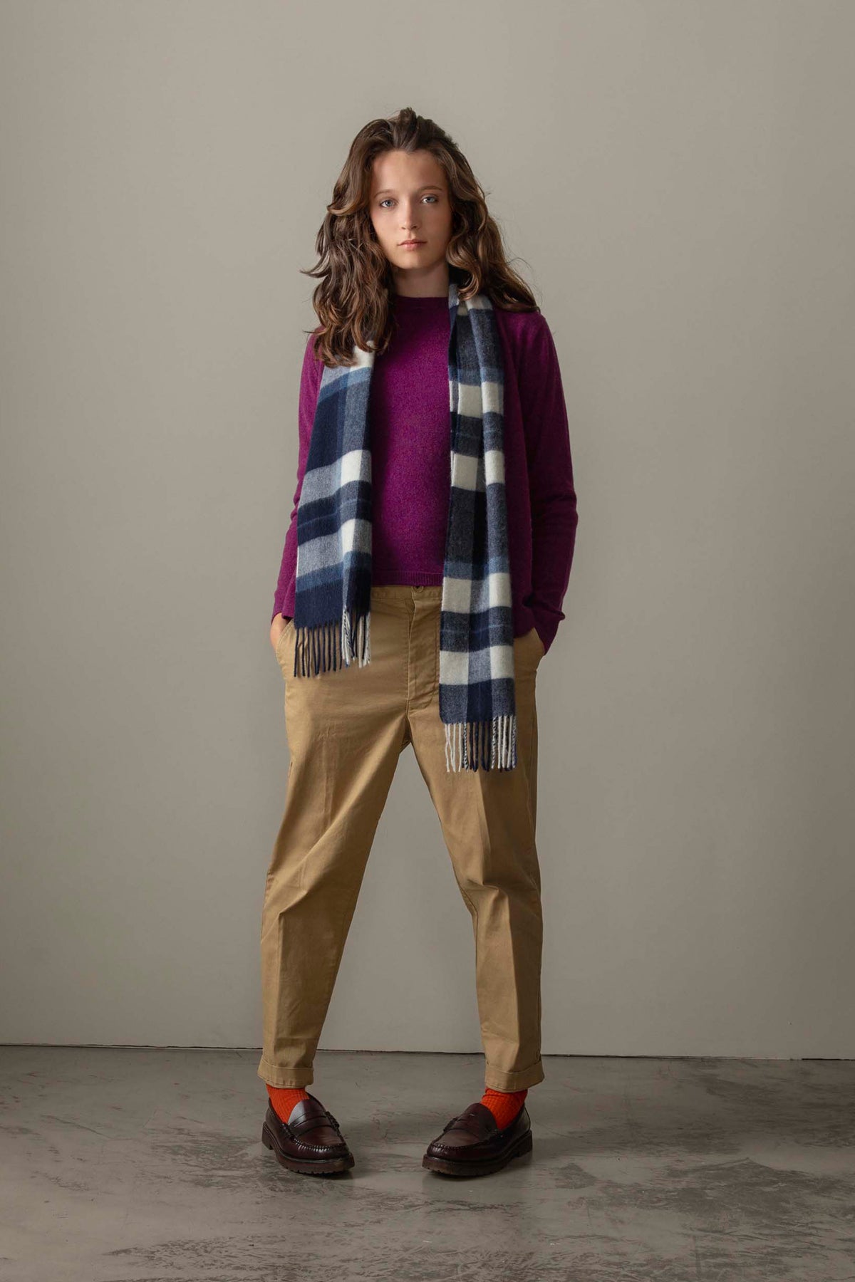 Made In Scotland Contemporary Cashmere Scarf in Chatham Navy, navy and cream check pattern with fringed ends, styled over a purple sweater