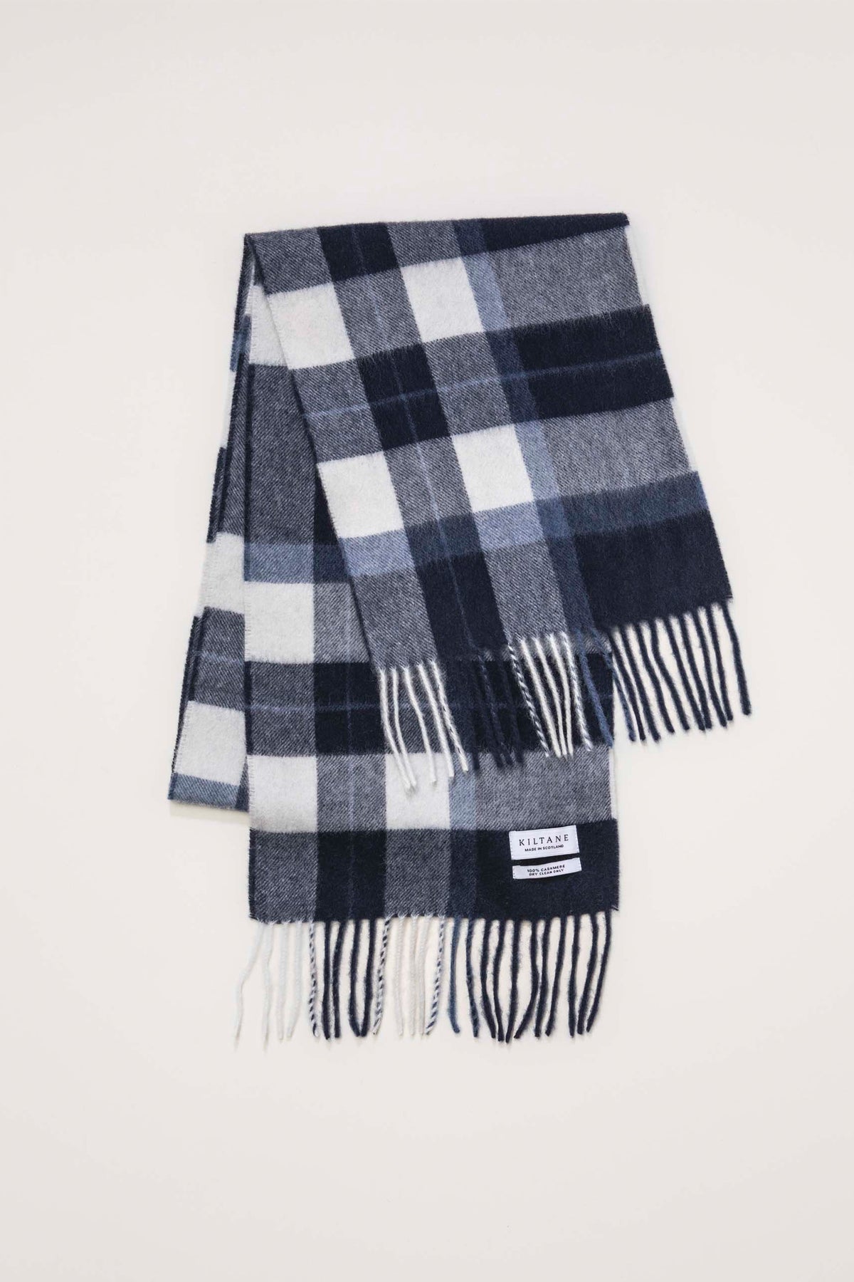 Kiltane Made In Scotland Contemporary Cashmere Scarf in Chatham Navy, folded flat showing check pattern and fringed ends