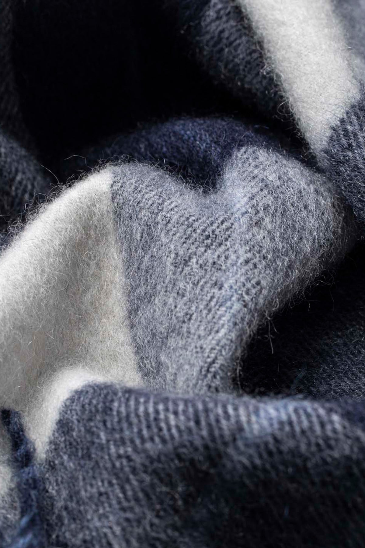 Close-up of the soft knit texture on the Made In Scotland Contemporary Cashmere Scarf in Chatham Navy and grey tones