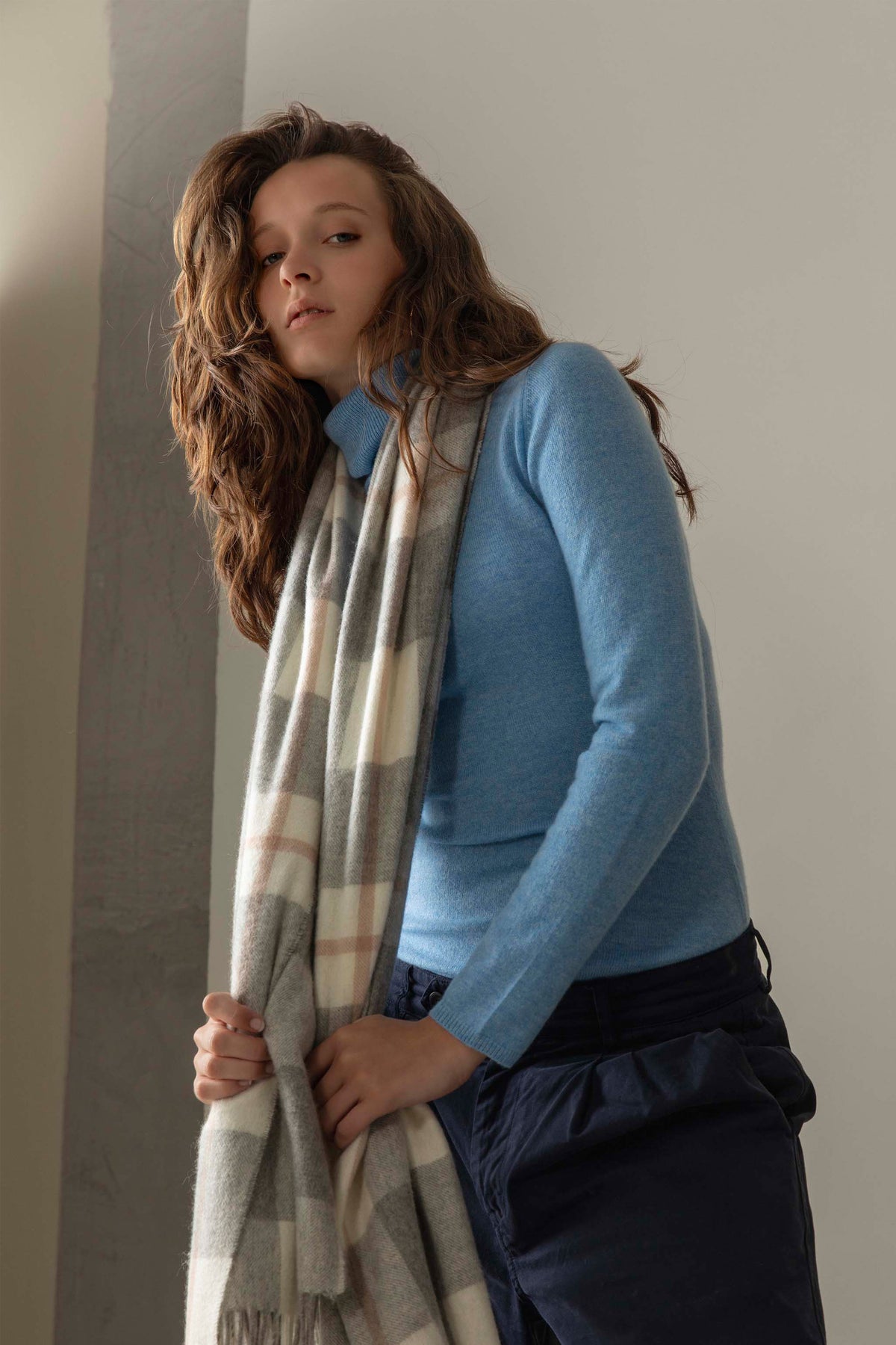 Made In Scotland Contemporary Check Cashmere Stole in Grey, soft check pattern in grey and cream, draped over a blue sweater