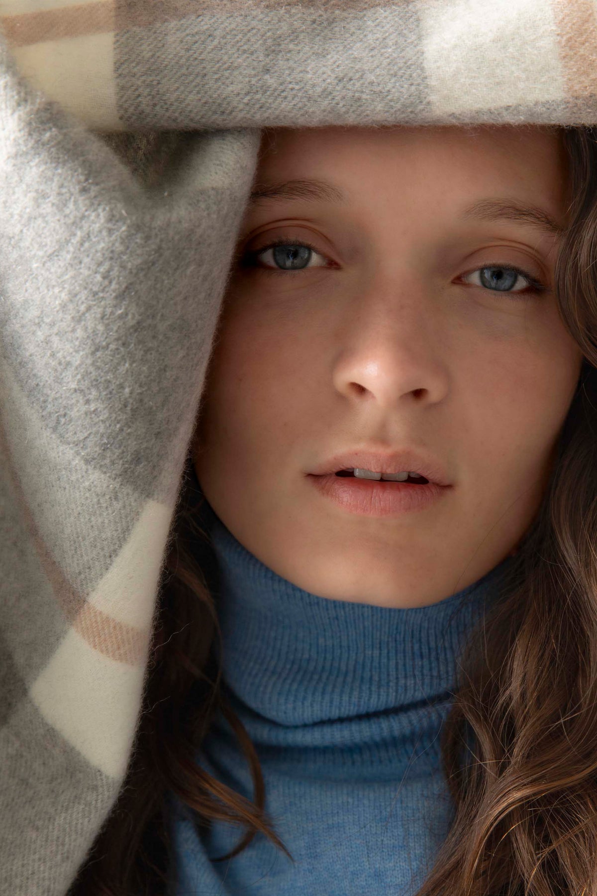 Made In Scotland Contemporary Check Cashmere Stole in Grey draped over model's head, showing soft wool texture and check pattern