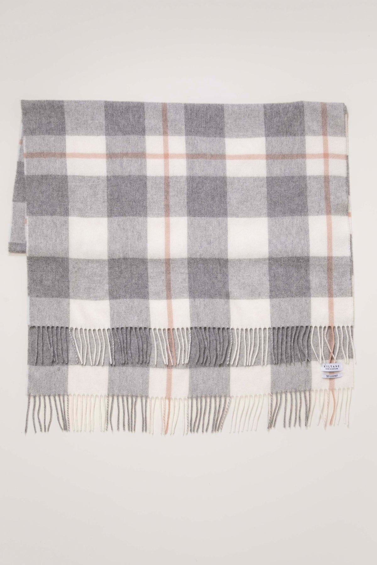 Made In Scotland Contemporary Check Cashmere Stole in grey laid flat showing full check pattern with pink accent lines and fringed ends