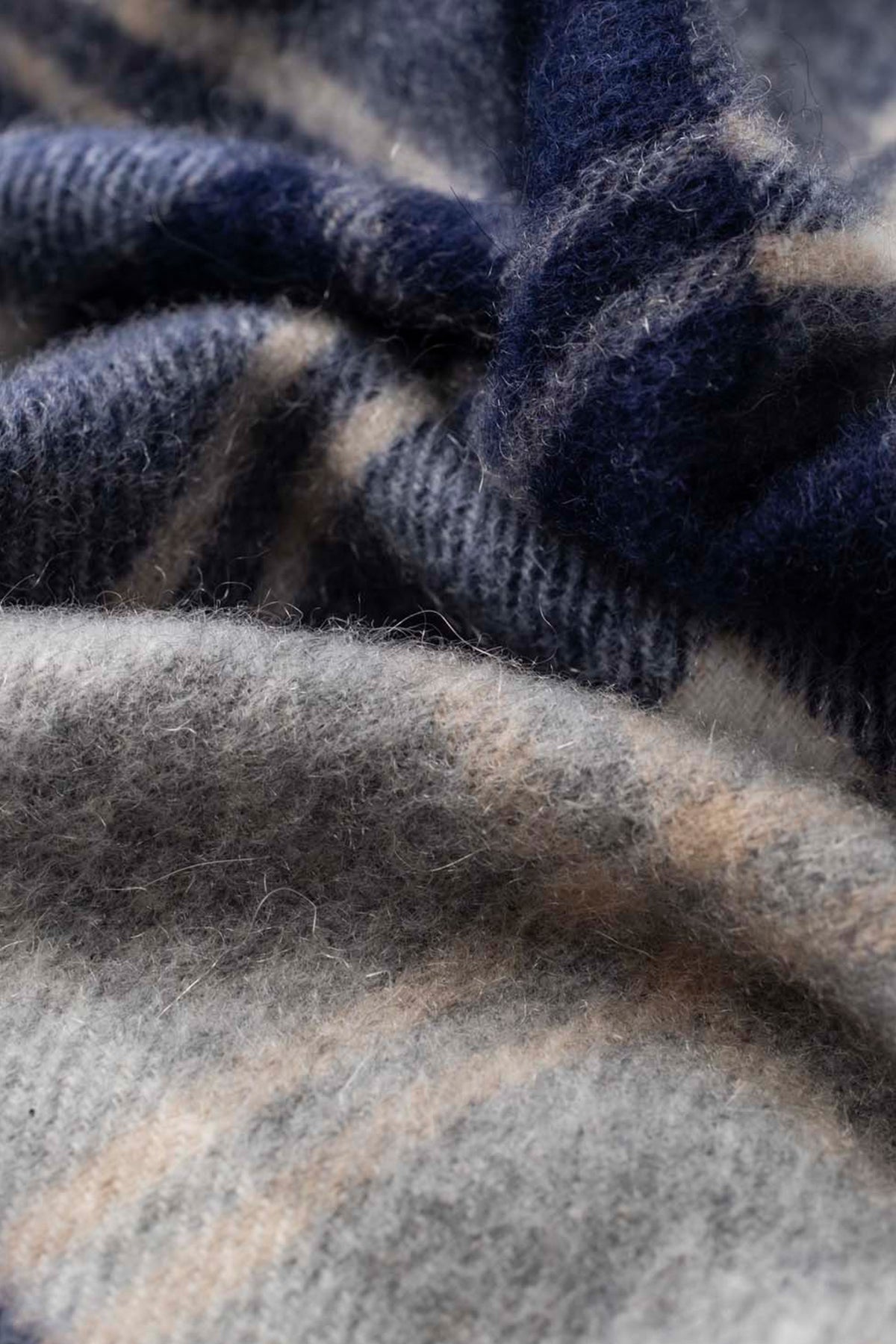 Close-up of the soft brushed cashmere texture on the Silver Bannockbane Heritage Cashmere Stole in navy and grey plaid