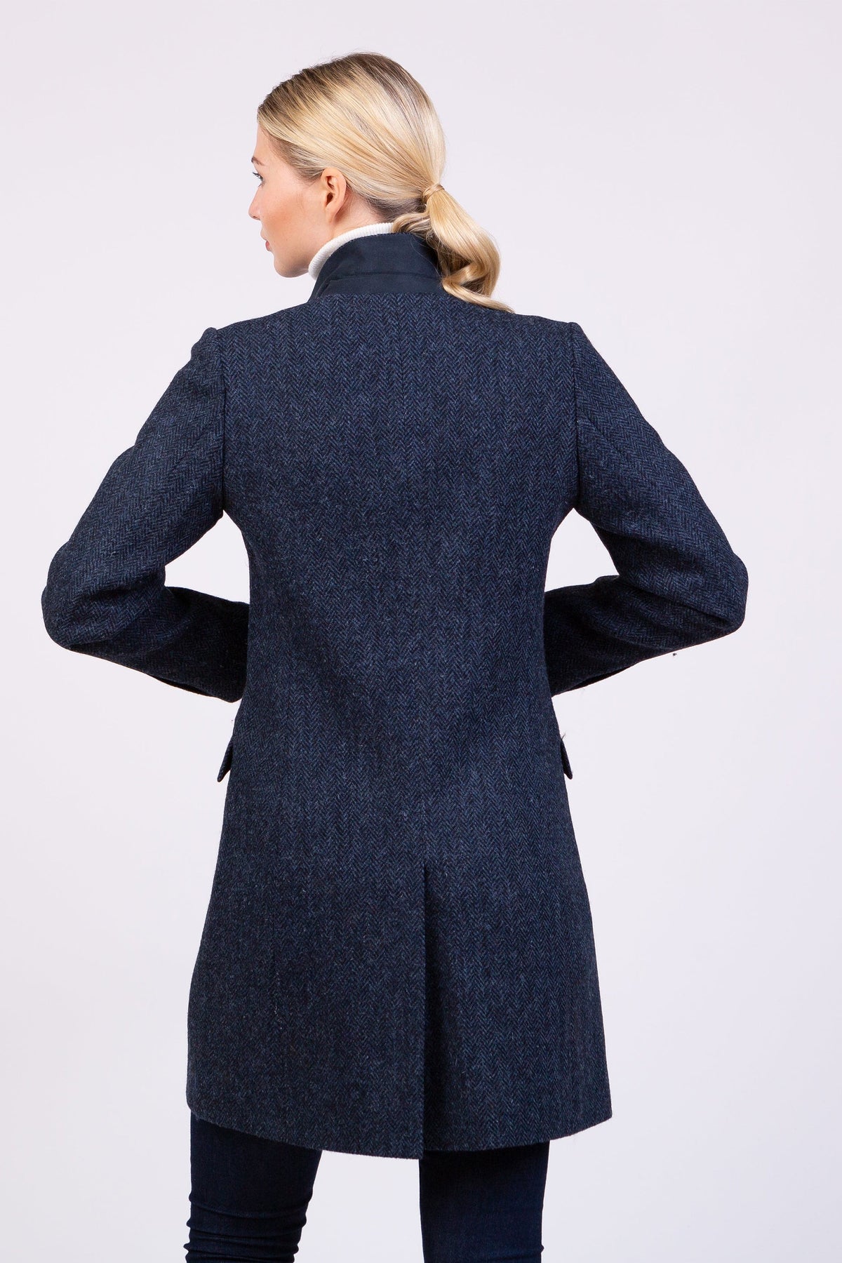 Back view of Women's Harris Tweed Tori Coat in dark navy blue herringbone showing tailored seams and centre back vent