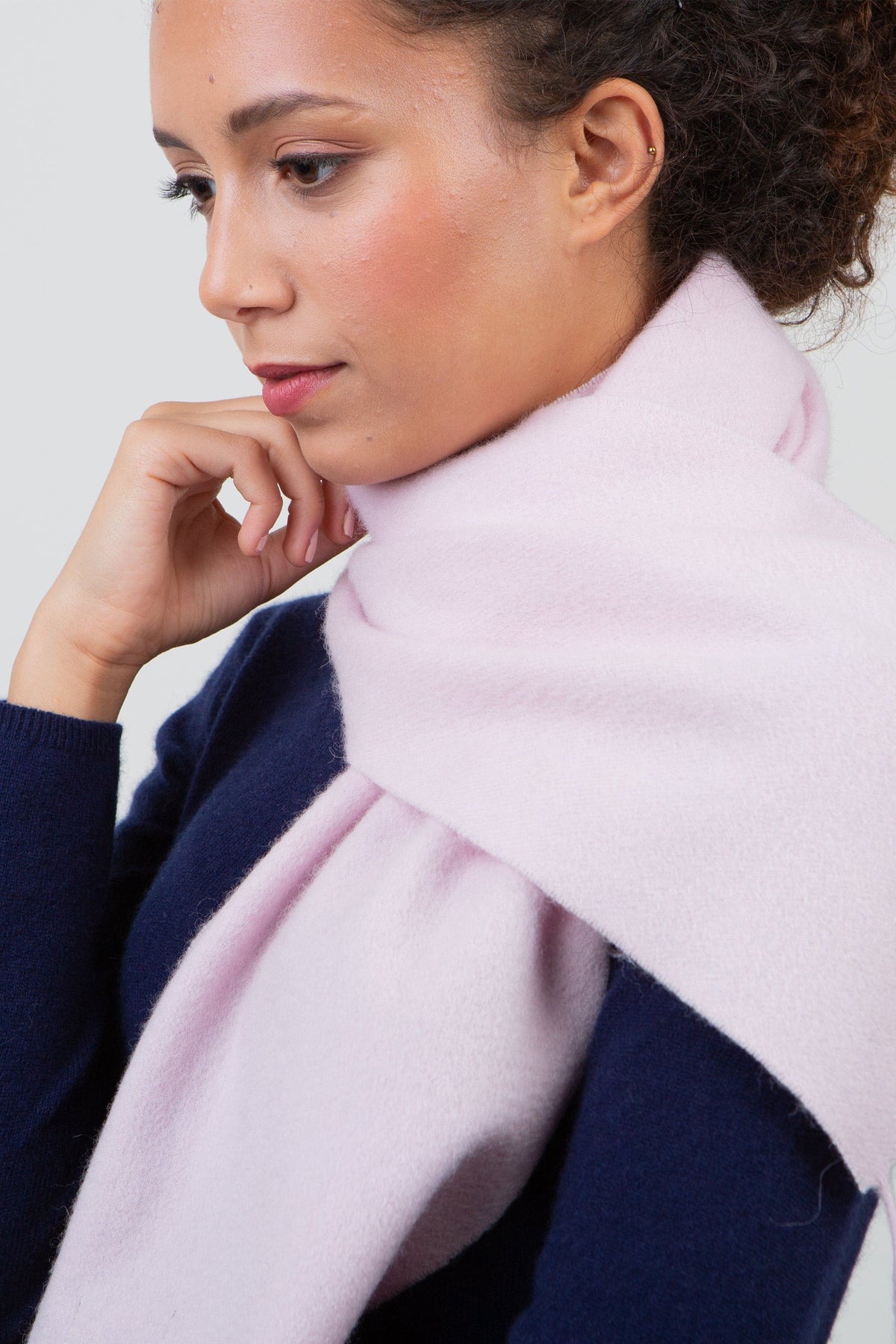 Solid Lambswool Scarf in Pale Lilac worn loosely knotted around the neck over a navy sweater, showing soft brushed texture