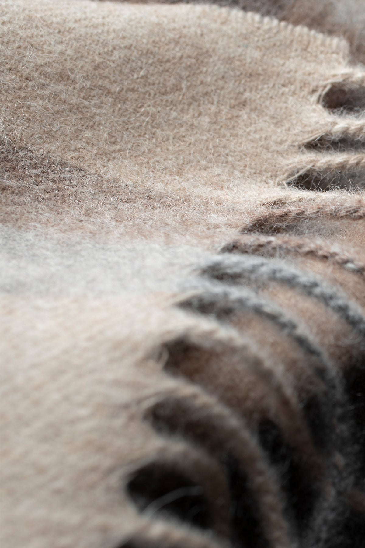 Close-up of Tartan 2 Lambswool Scarf in Natural showing soft brushed texture and fringed edge detail