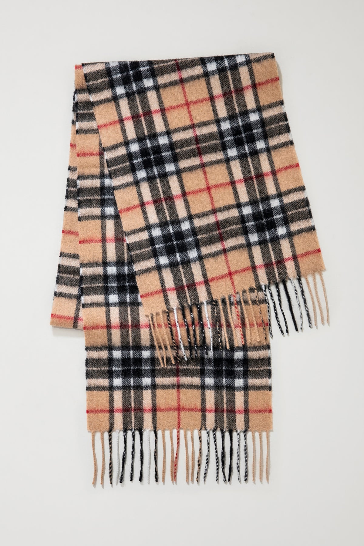 Scotty Thompson Lambswool Scarf in Camel folded flat showing full check pattern with black, red, and white stripes and twisted fringe ends