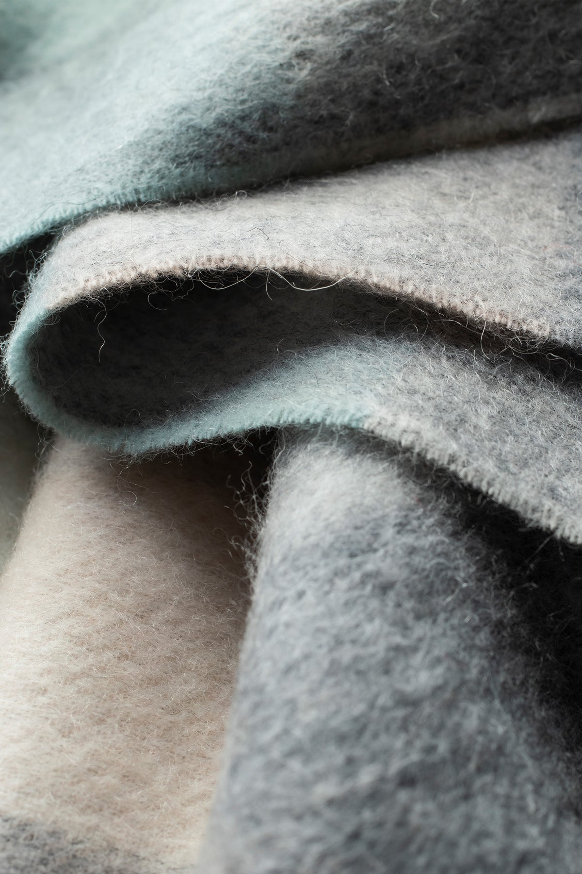 Close-up of 5 Square Check Lambswool Scarf in Brume showing soft brushed texture and teal-to-cream gradient