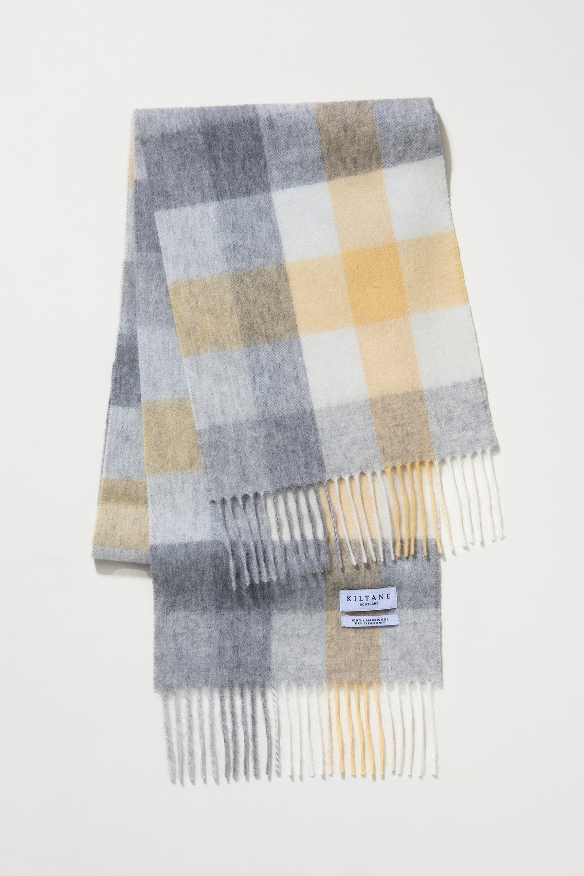 5 Square Check Lambswool Scarf in Butter folded to show Kiltane Scotland label and fringed ends in grey, gold, and cream