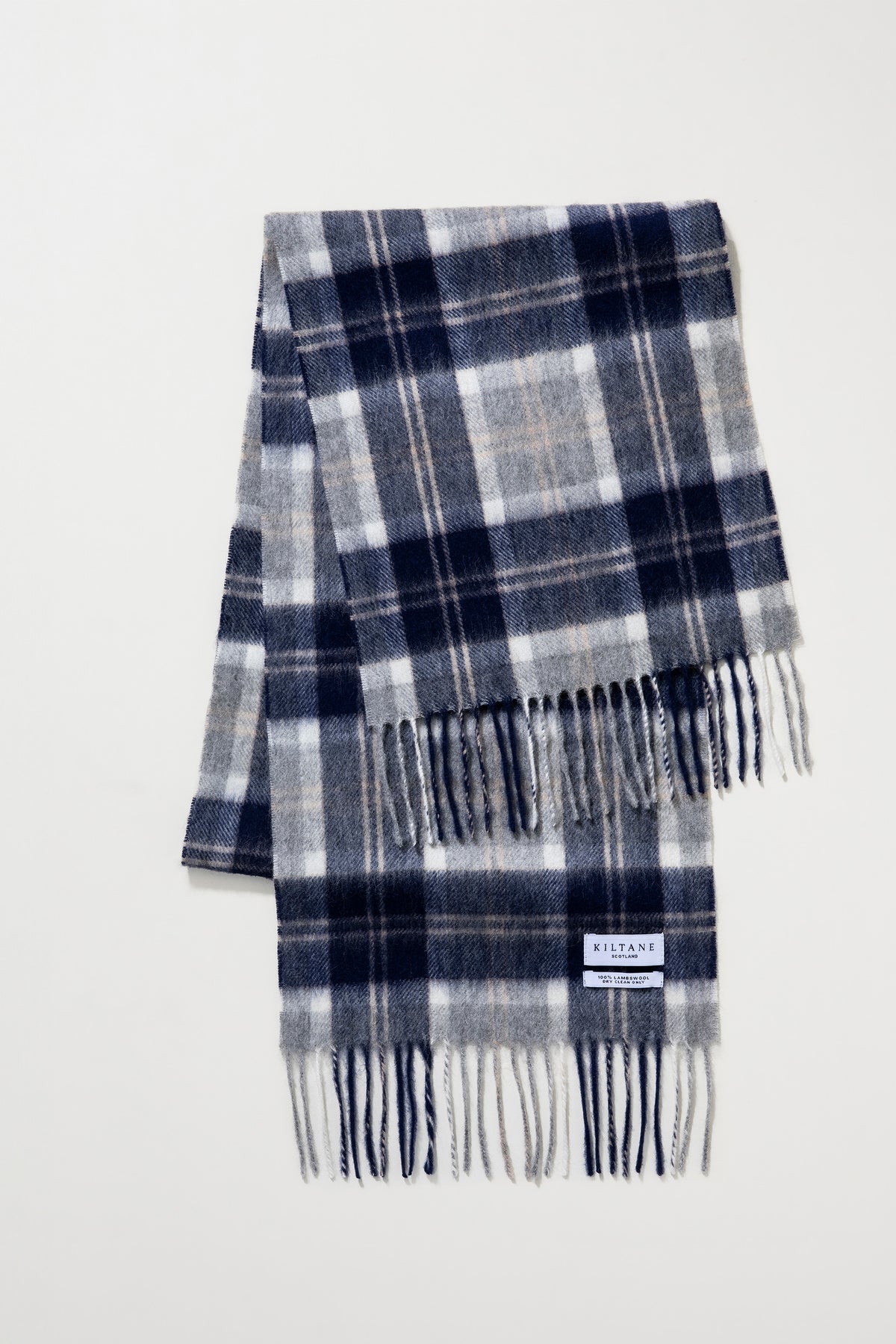 Heritage Tartan Lambswool Scarf in Silver Bannockbane folded flat showing navy, grey, and white plaid pattern with fringed ends