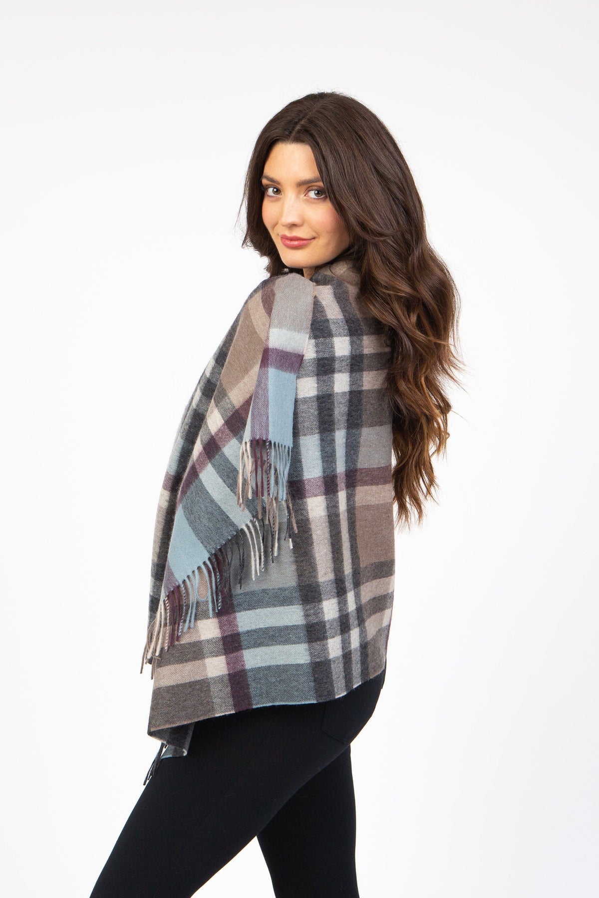 Model wearing Tartan 2 Lambswool Stole in Blue Taupe draped over shoulders, showing plaid pattern and fringed edges from the back