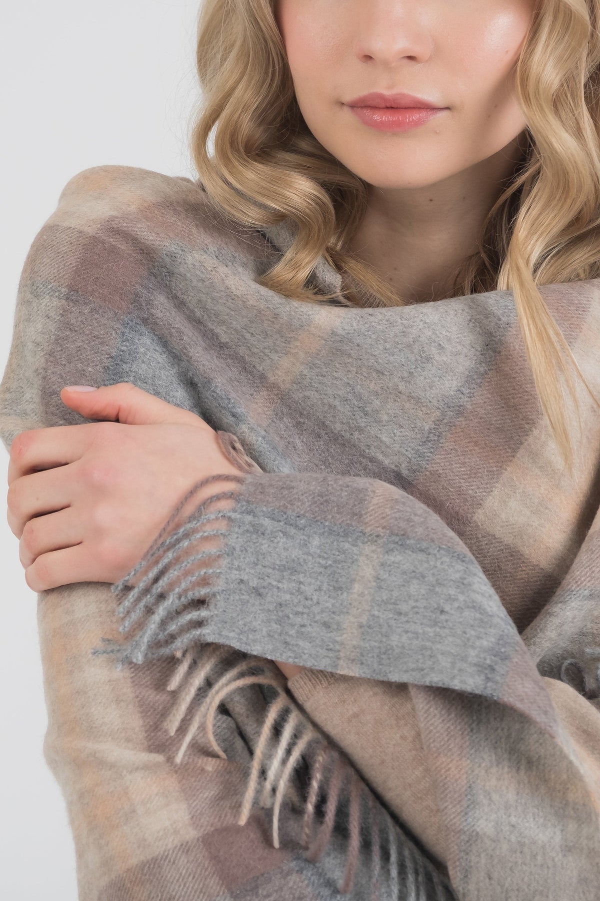 Heritage Tartan Lambswool Stole in Mackellar Natural wrapped around shoulders, showing soft plaid pattern and fringed edges