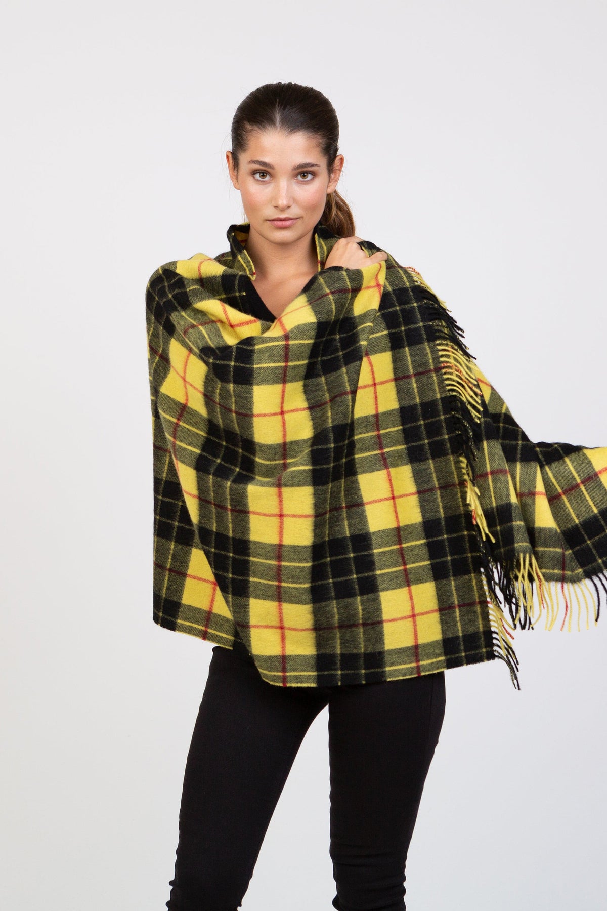 Heritage Tartan Lambswool Stole in Macleod pattern, yellow and black plaid with red accents and fringed edges, worn draped over shoulders