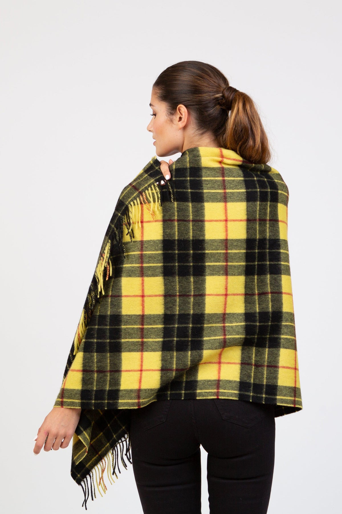 Back view of Heritage Tartan Lambswool Stole in Macleod pattern, showing yellow and black plaid drape with fringed edges