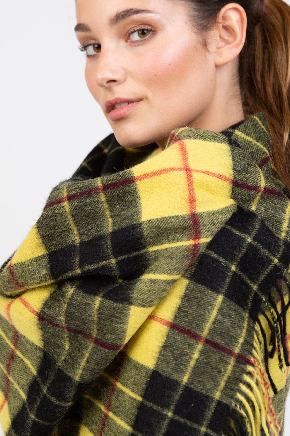 Close-up of Heritage Tartan Lambswool Stole in Macleod pattern showing soft wool texture with yellow, green, black, and red plaid