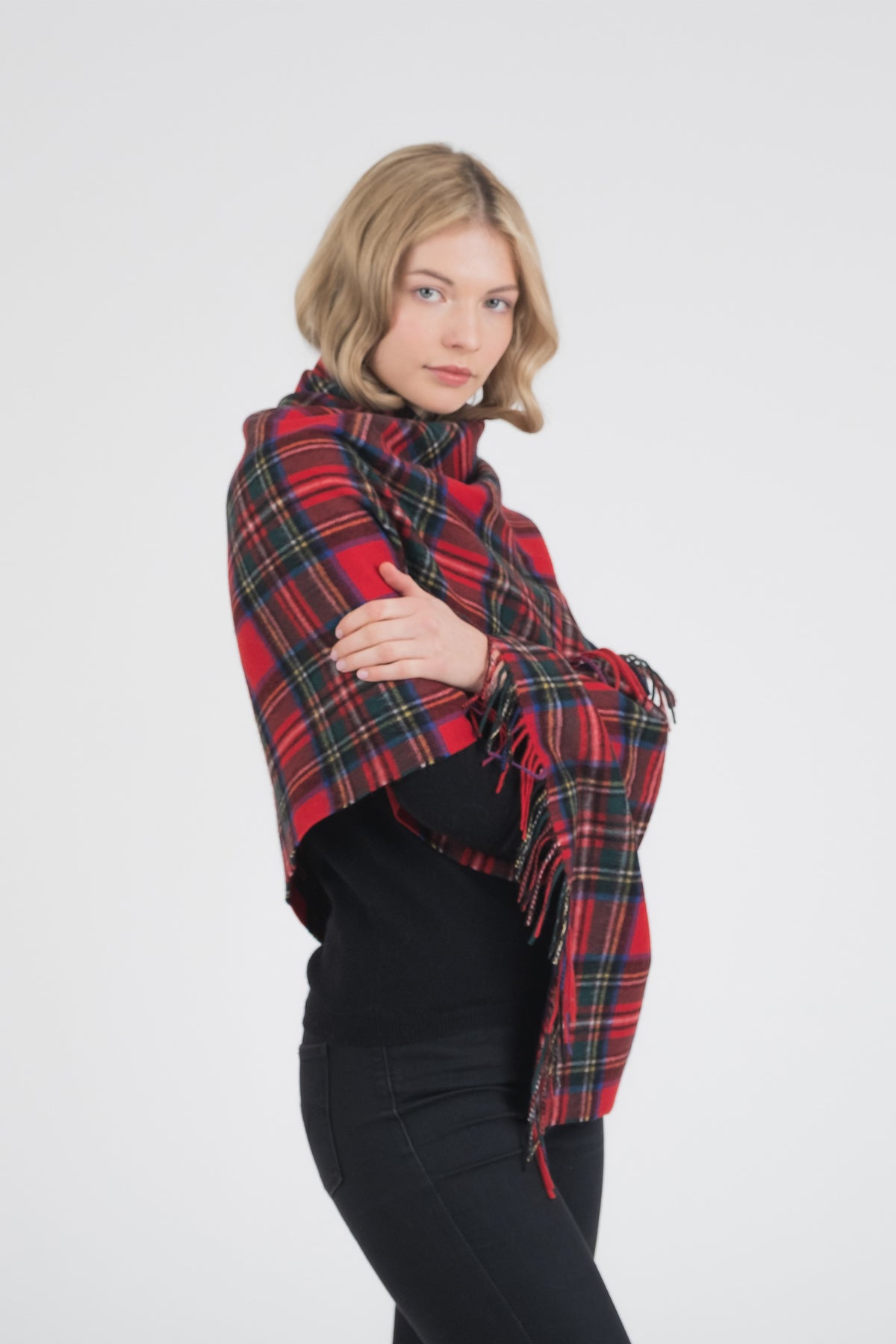 Heritage Tartan Lambswool Stole in Royal Stewart worn wrapped around shoulders, showing fringed edges and red plaid pattern