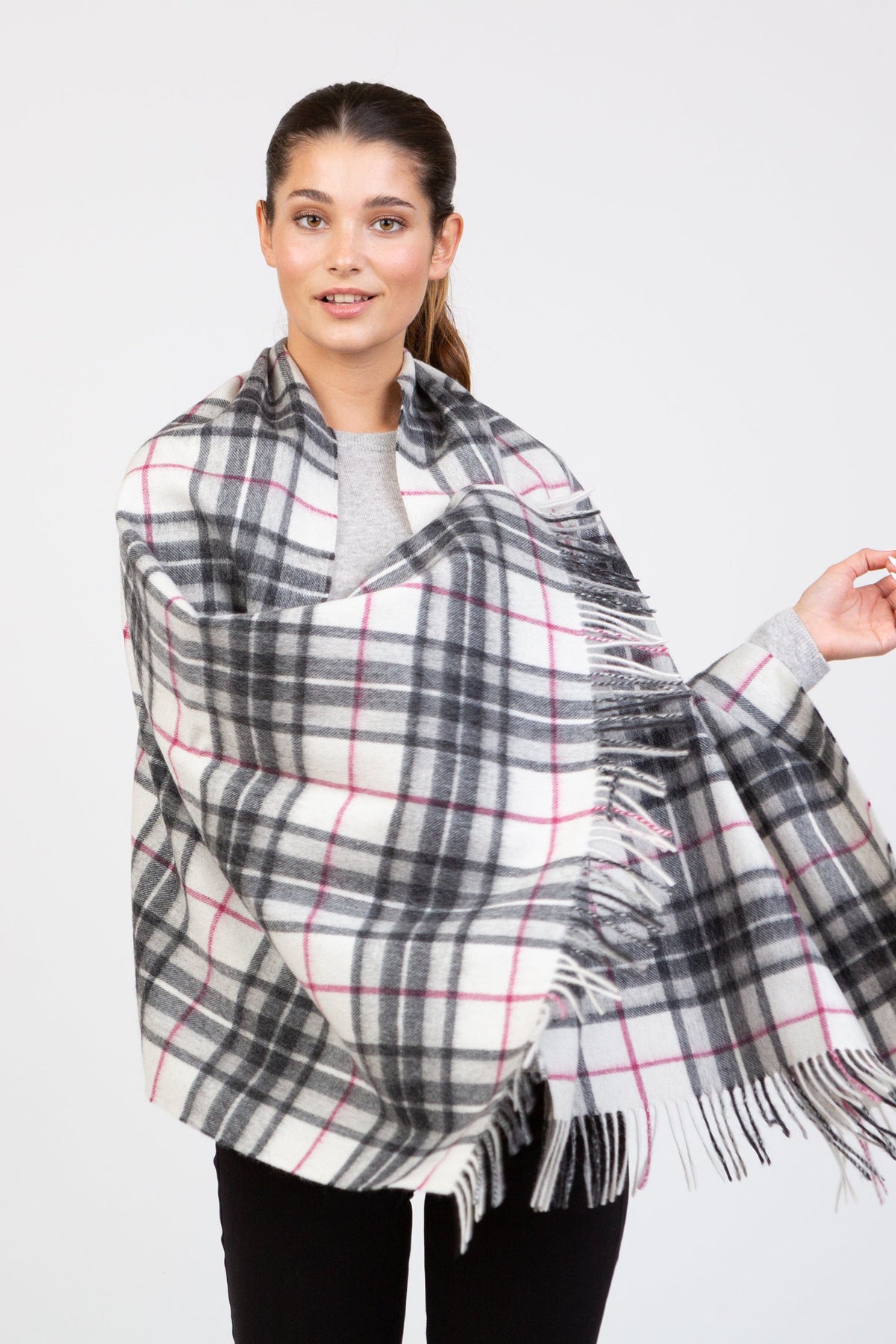 Scotty Thompson Lambswool Stole in white with charcoal and pink plaid pattern, fringed edges, worn draped over shoulders