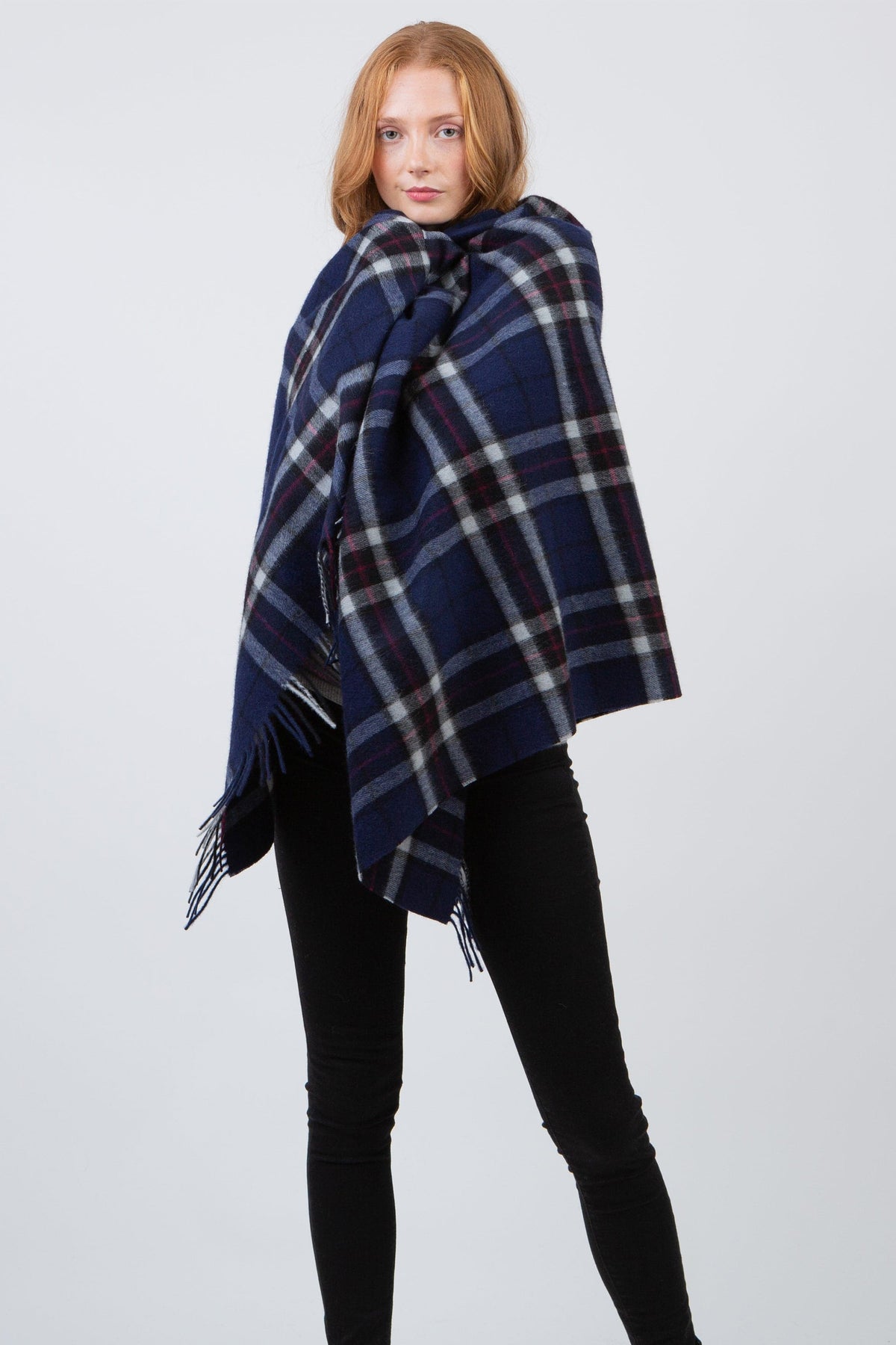 Scotty Thompson Lambswool Stole in Navy, a large plaid wrap in navy, white, and burgundy with fringed edges, worn draped over shoulders