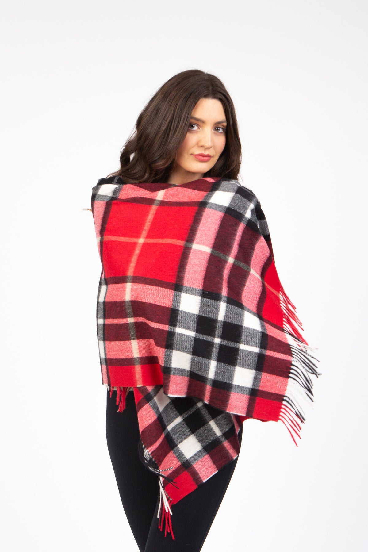 Scotty Thompson Lambswool Stole in Red, a large tartan plaid wrap in red, black, and white with fringed edges, modelled draped over shoulders