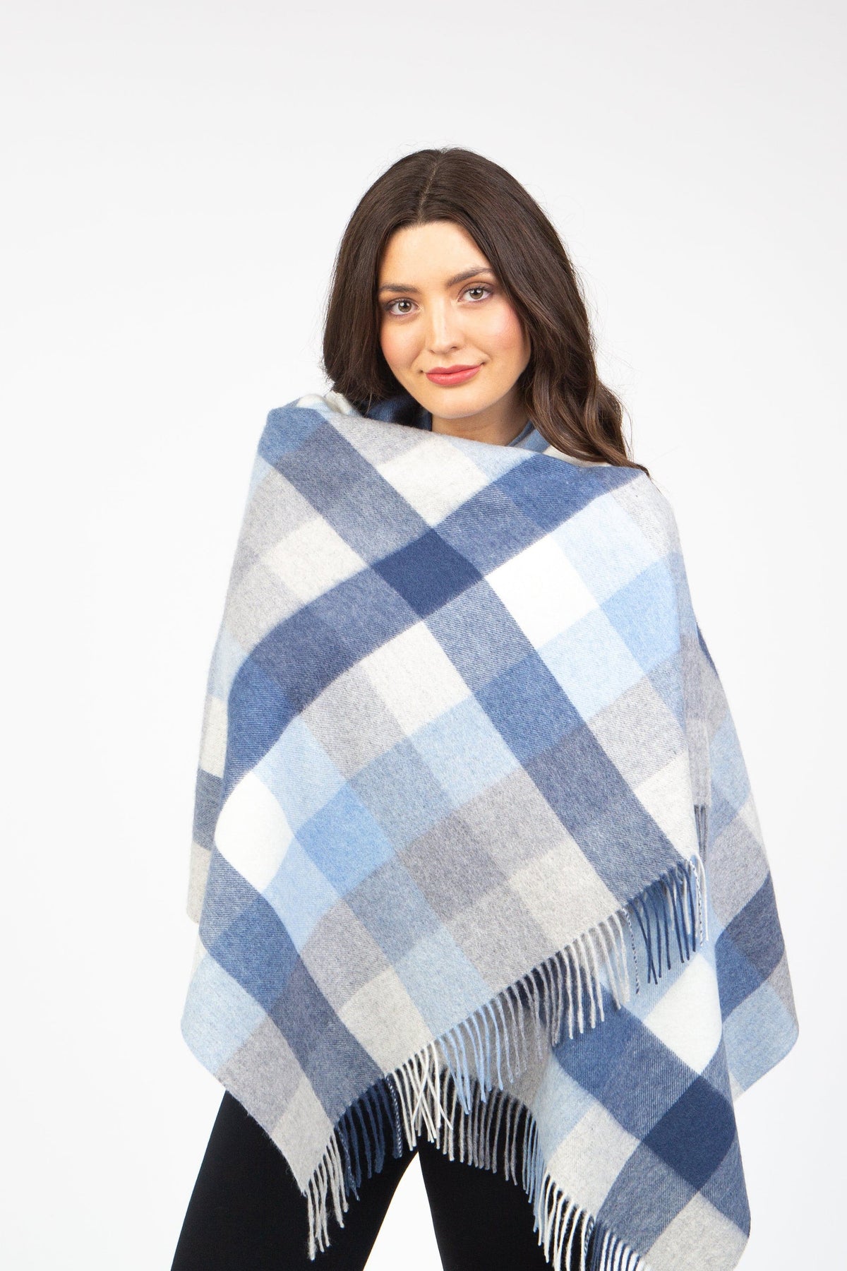 5 Square Check Lambswool Stole in Glacier, a blue and grey plaid wrap with fringed edges, modelled draped over shoulders