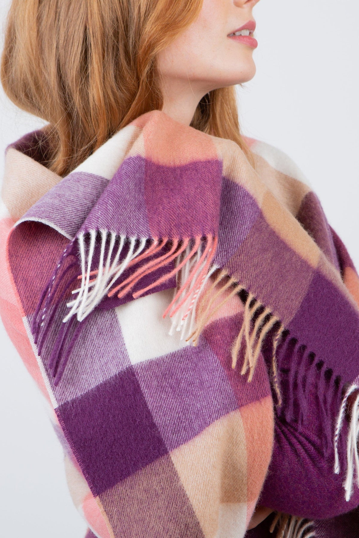 Close-up of 5 Square Check Lambswool Stole in Eminence showing multicoloured fringe detail and purple, pink, and cream check pattern