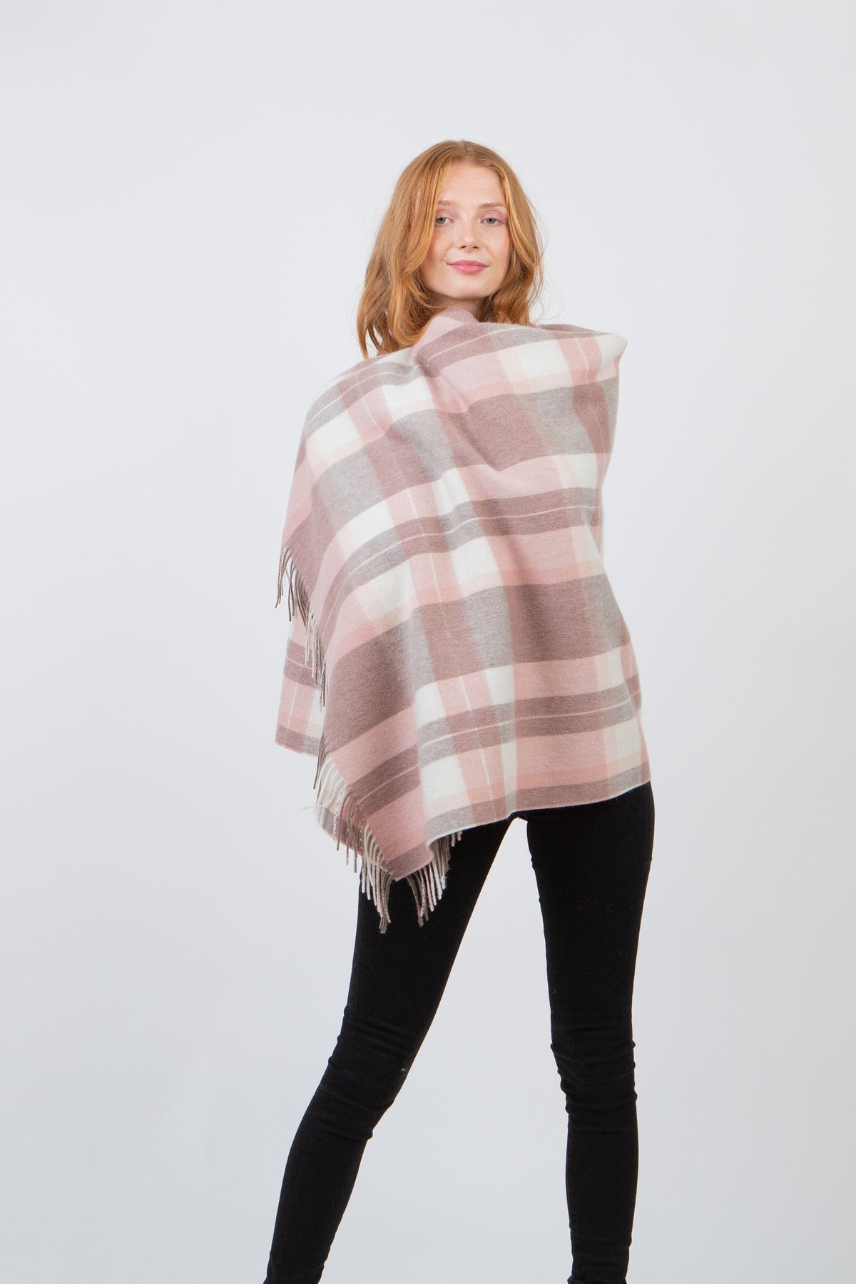 Contemporary Check Lambswool Stole in Cameo, pink and grey plaid wrap with fringed edges, modelled draped over shoulders