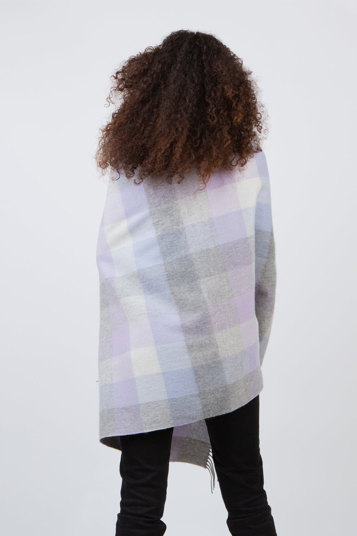 Back view of model wearing 5 Square Check Lambswool Stole in Lilac draped over shoulders, showing full check pattern in lilac and grey