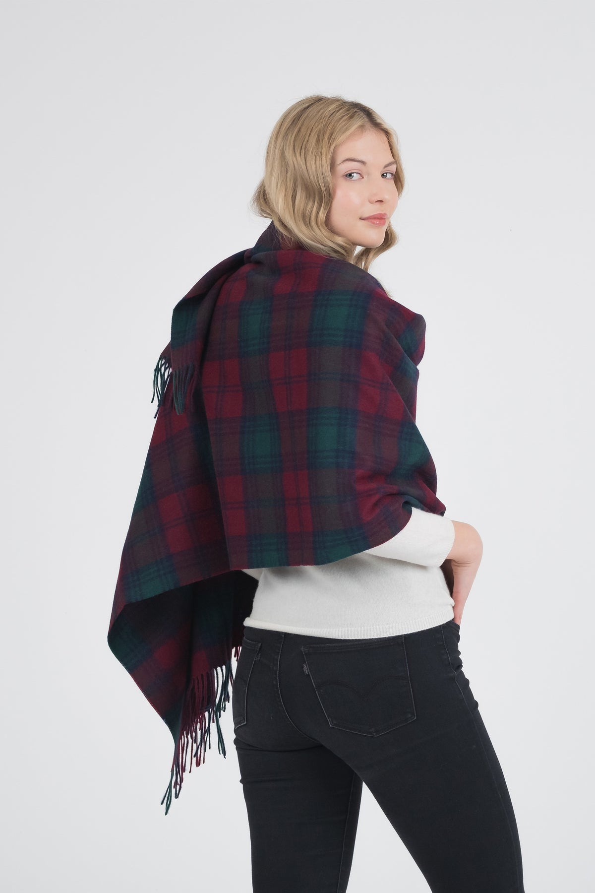 Heritage Tartan Lambswool Stole in Lindsay pattern worn draped over shoulders, back view showing red and green plaid with fringe detail