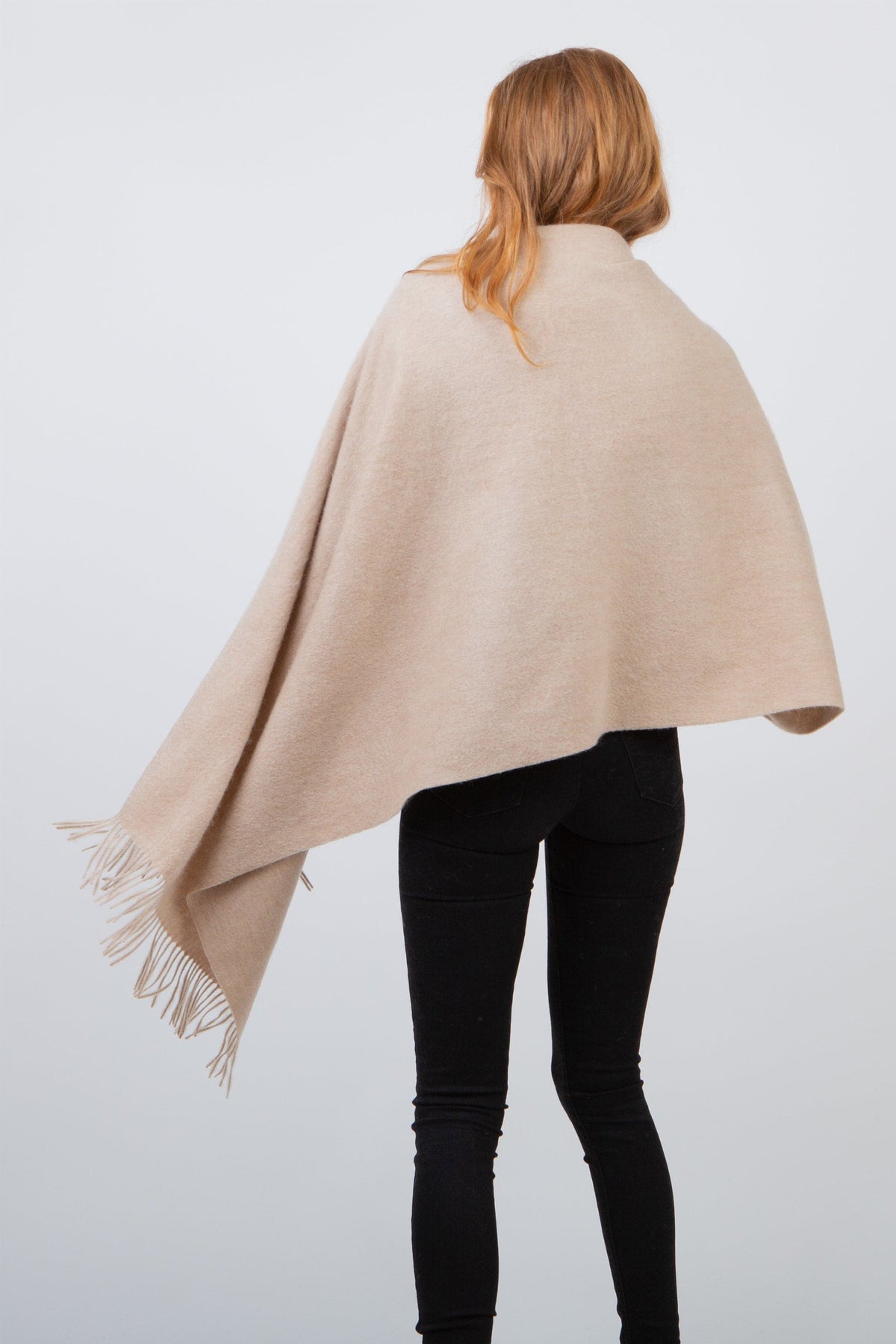 Back view of the Solid Lambswool Stole in Vicuna draped over shoulders, showing full coverage and fringed edge detail