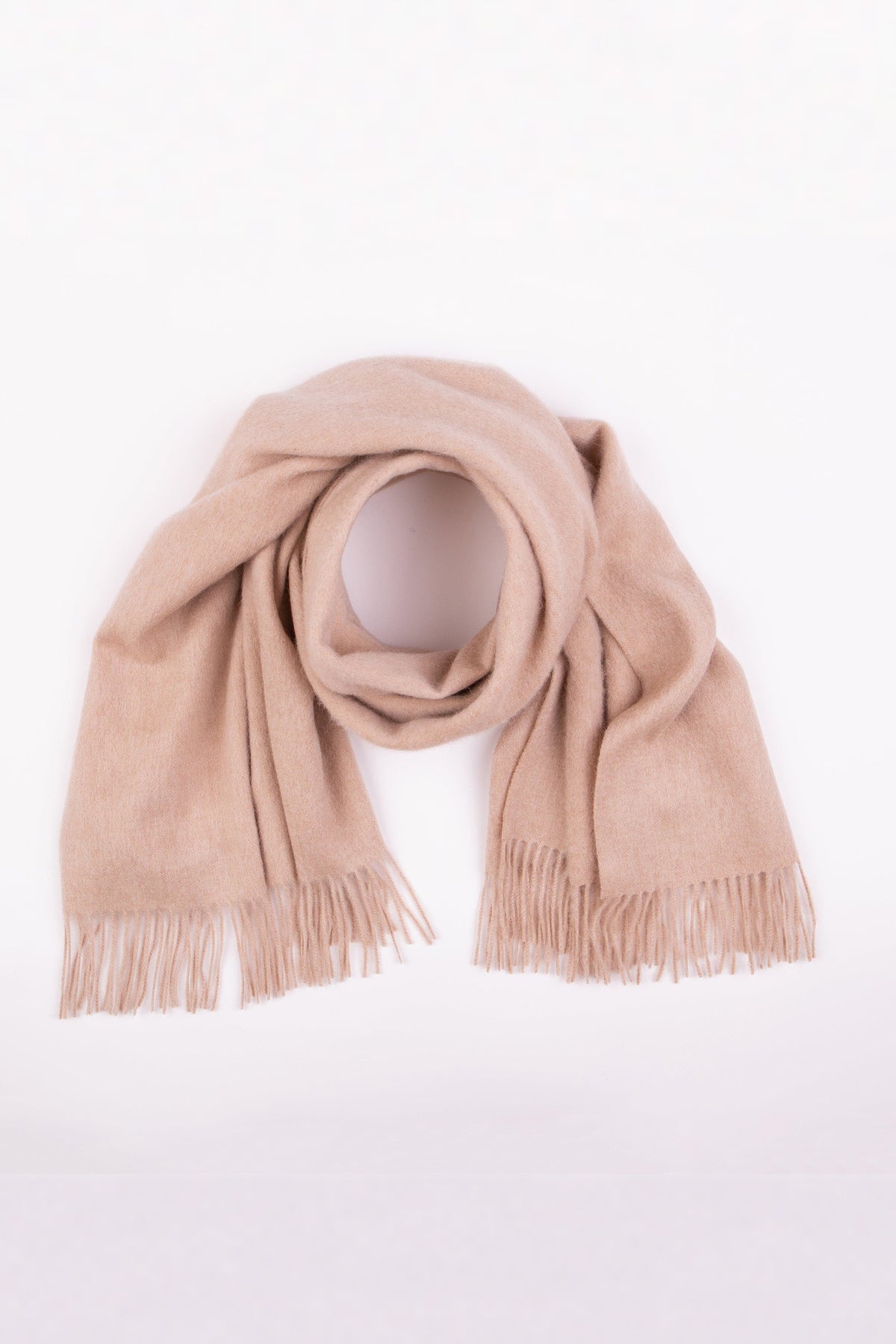 Solid Lambswool Stole in Vicuna loosely looped to display the soft texture and fringed ends against a white background