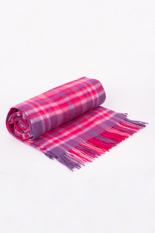 Lambswool Throw in Purple Pink Exploded Check, rolled up showing soft plaid pattern with fringed edge