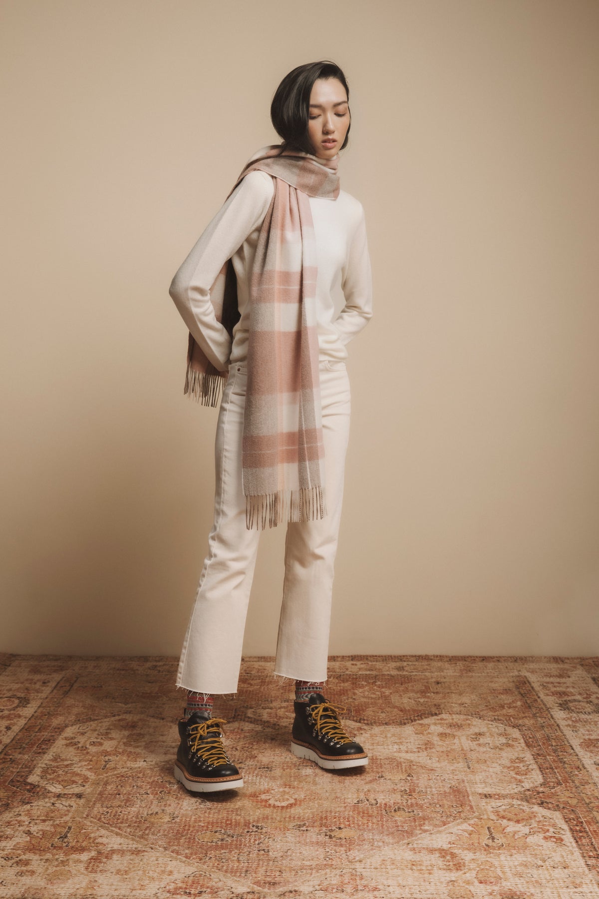 Contemporary Check Cashmere Wide Scarf in Cameo Check styled on model, showing full drape length with fringed ends over an all-cream outfit