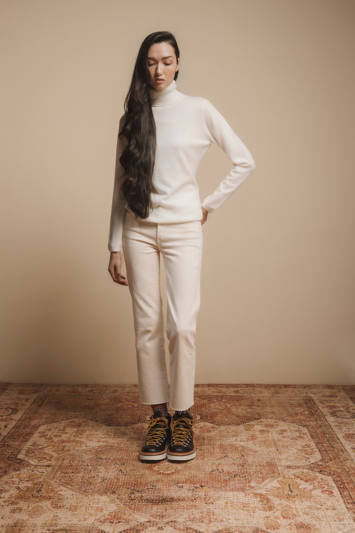 Women's Cashmere Polo Neck Jumper in Soft Cream styled full-length with cream trousers and hiking boots